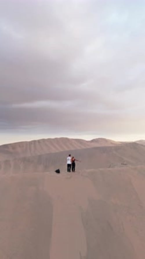 Aerial View of Sand Dunes in Peru Capturing the Serenity of the Ica Desert and a Small Town at