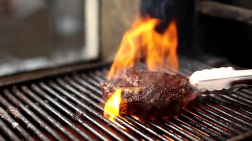 Juicy Steak Sizzling on a Fiery Grill