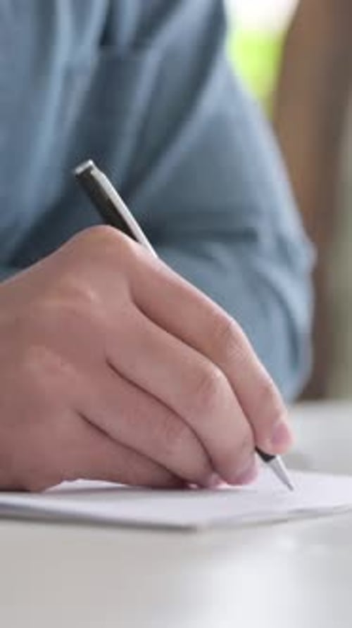 Close Up of Hand Writing on Paper with Pen, Vertical Video