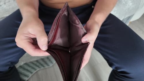 Wallet without money in the hands of a man