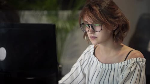 Woman Works at Computer in Modern Office