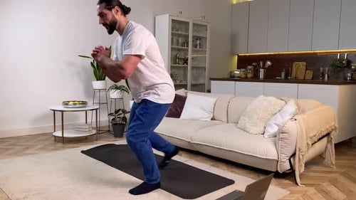 Man Doing Lunges at Home on Yoga Mat