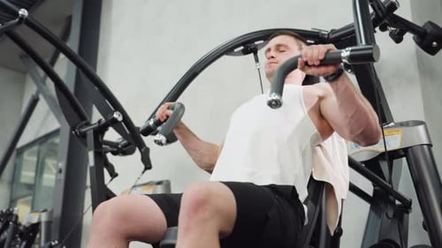 Keep Fit Buff Working Out On Chest Press Machine