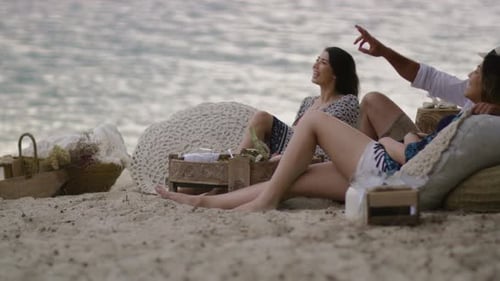 Sexy Millennial Friends Hang Out at a Picnic on Sandy Beach At
