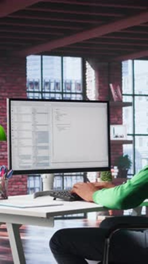 Man Coding at a Computer in Modern Office