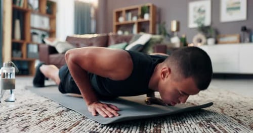 Athletic Young Adult Does Push Ups Indoors