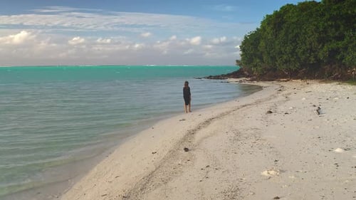 Woman Walking on a Pristine White Sand Beach in Tropical Paradise