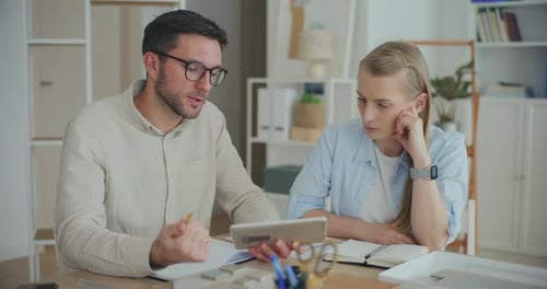 Interior Designers Working At Desk In Office Planning Interior Design