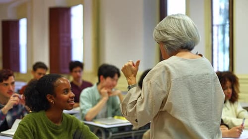Senior Female Professor Lecturing Diverse Students in University Classroom