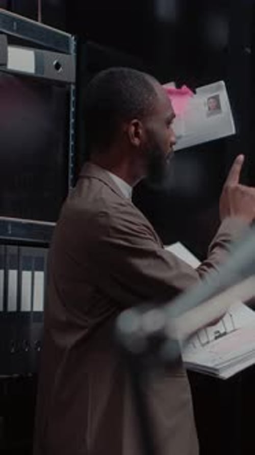 Man in Suit Reviews Documents Indoors