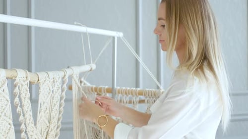 charming girl quickly weaves macrame