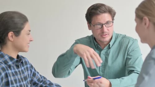 Adults in Office Having Discussion at Table