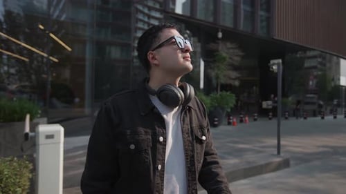Latin Male Traveler Stopping to Observe Modern Urban Architecture