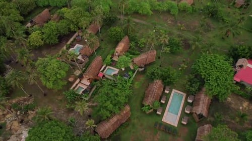 Luxurious cabin villas with pool in tropical Caribbean paradise. Aerial top down