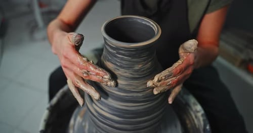 Woman Creating Pottery on a Spinning Wheel