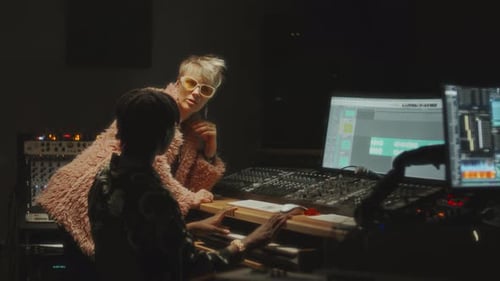 Female Singer and Sound Engineer Having Discussion in Recording Studio