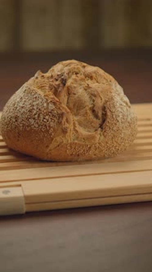 Golden Sourdough Loaf on Cutting Board, Close Up