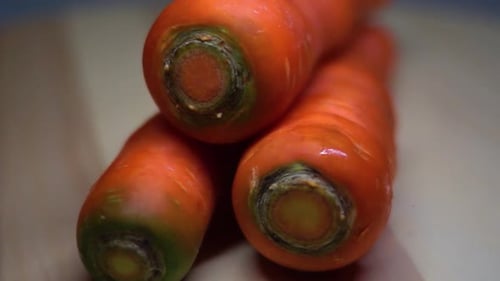 close up of three carrots with a rotating shot