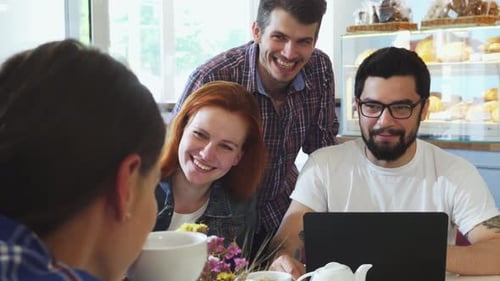 Group of Friends Joyfully Enjoying Breakfast Together at a Cozy Coffee Shop