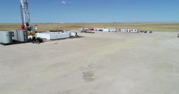 Drone flight over a fracking pad focusing on a semi truck and working ...