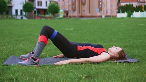 Woman Doing Glute Bridge Exercise With Resistance Band