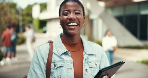 Smiling Student Holds Tablet on Campus
