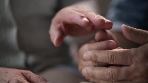 Loving Senior Couple Holding Hands Intimately Together