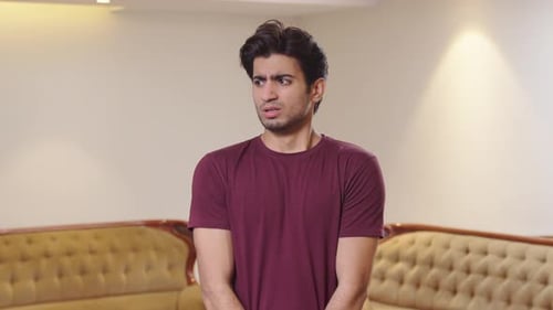 Young Man Looking Anxious and Concerned Indoors