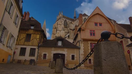 View of a Beautiful Street with Old Traditional French Houses in the Center of Auxerre with Clouds