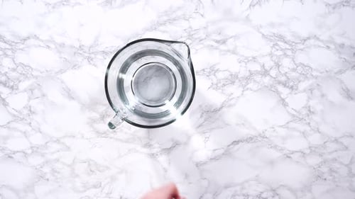 Measuring Water with Glass Pitcher and Cup