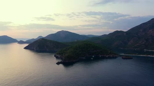Scenic Landscape of Sea Bay and Green Mountains at Sunset