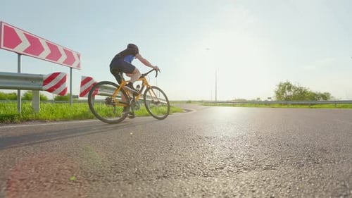Male Athlete Training Hard on Bicycle Outdoors