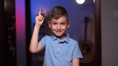 Smiling Boy with Idea Poses Indoors