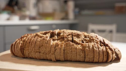 Crusty Sliced Bread Loaf on Cutting Board