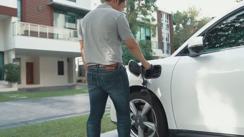 Progressive idea of charging electric vehicle via cable from charging station.