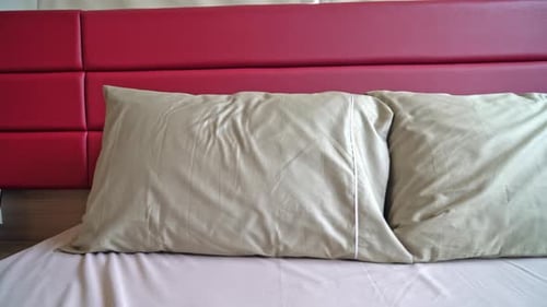 Bed with Gray Pillows and Red Headboard