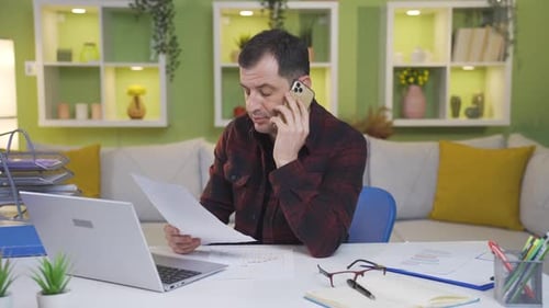 Man Working from Home on Phone Call