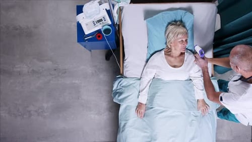 Doctor Caring for Covid Patient in Hospital