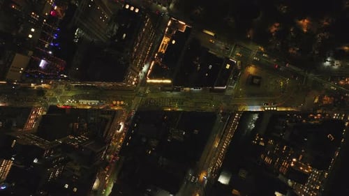 Aerial View of a Busy Intersection in Manhattan New York City at Night Cars are Driving Through