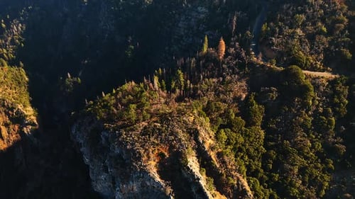 High rocks and cliffs of the mountainous area in California. Drone footage above the mountains