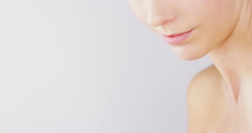 4k video footage of an alluring beautiful woman posing against a studio background