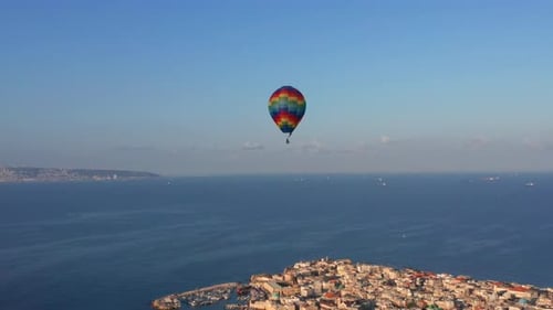 Hot air balloon passing over Acre old city port houses and Mosque at sunrise, Aerial view
