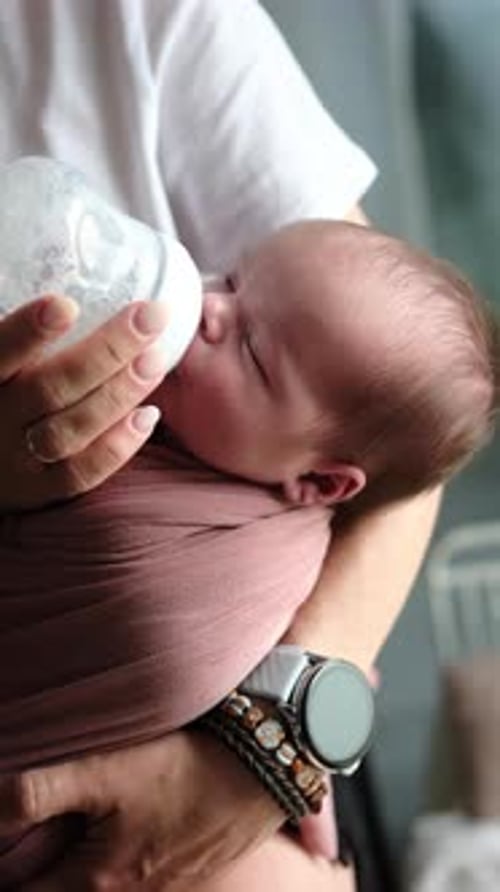 Newborn Baby Drinking Bottle in Natural Light