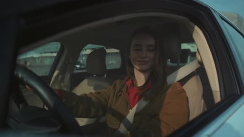 Woman driving car, looking at mirror