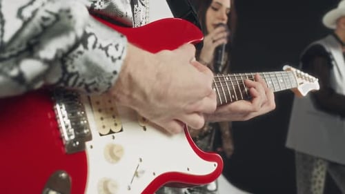 Anonymous Musician Playing Electric Guitar While Performing with Band