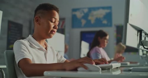 Focused Children Typing on Computers in a Classroom