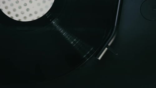 Spinning Vinyl Record on Black Turntable