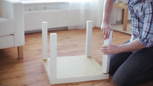 Furniture, Home and Moving Concept - Close Up of Male Hands Assembling