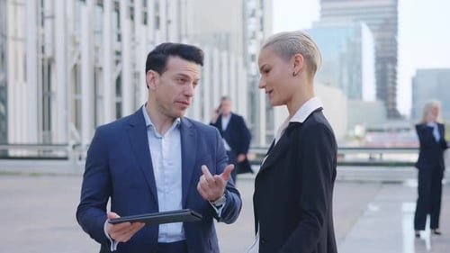 Businessman Talking with a Colleague in the Street