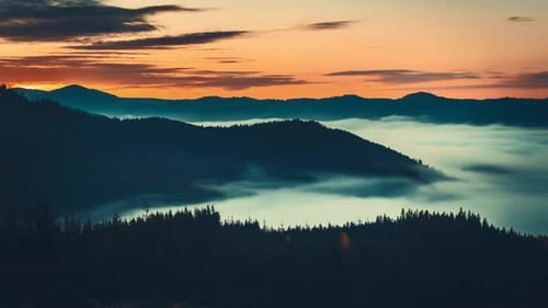 Foggy Morning is Covering the Carpathian Mountains with Colorful Sky